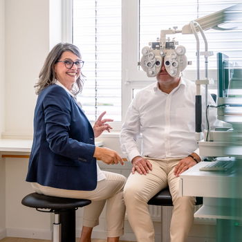 Das Bild zeigt eine Mitarbeiterin, die einen Sehtest durchführt.