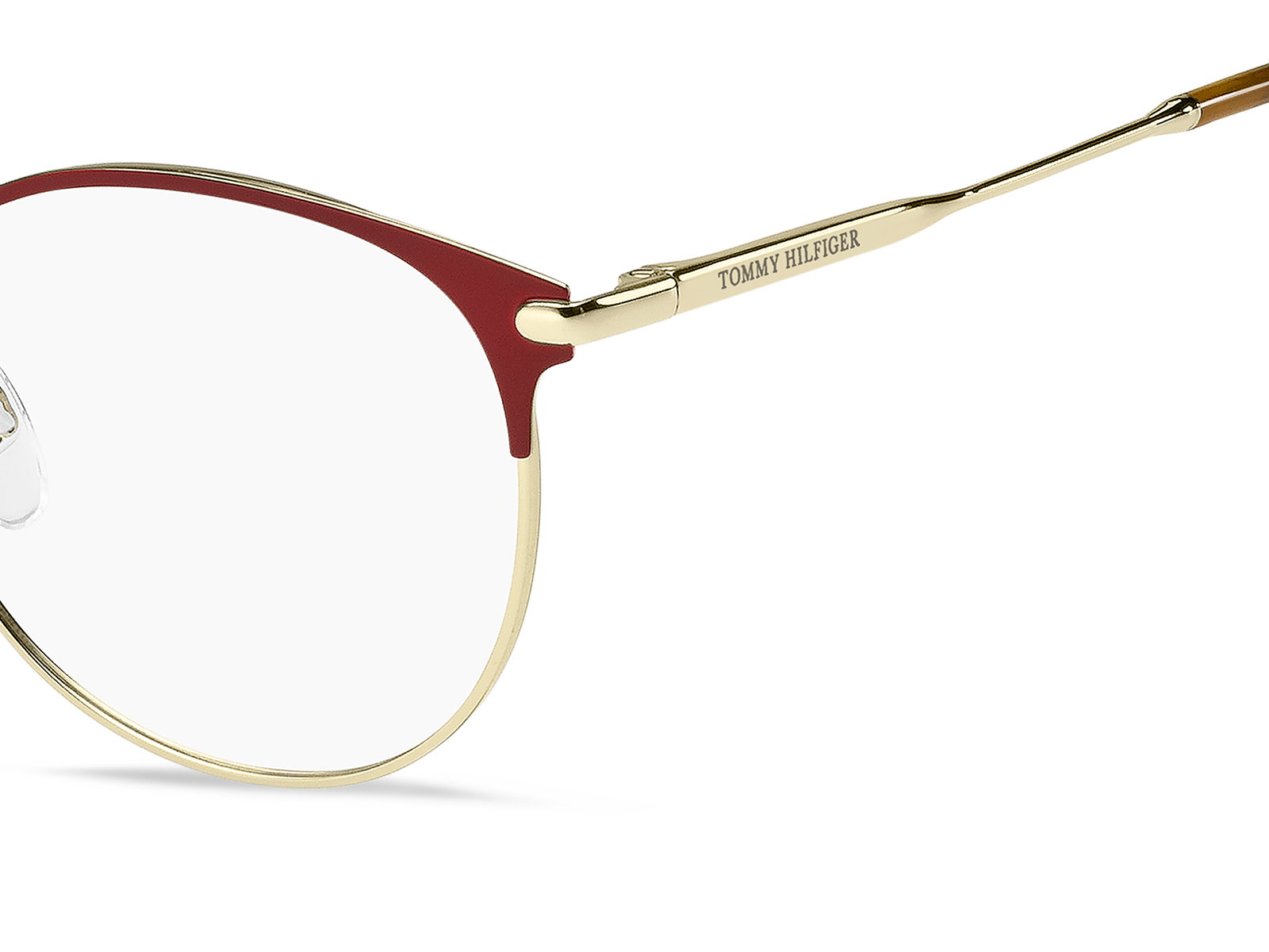 Das Bild zeigt die ovale Brille TH1959 für Damen von der Marke Tommy Hilfiger in gold rot von rechts
